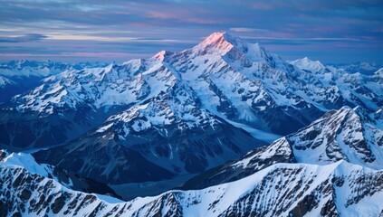 Obraz premium Aerial view of mount cook covered in snow at sunrise with a colorful sky in new zealand