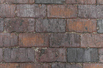 abstract background of an old red brick tiled pavement close up
