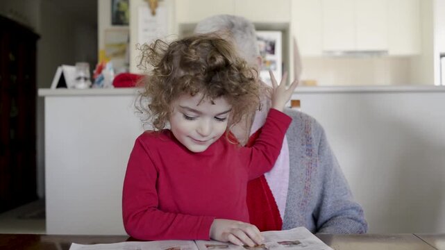 Happy Grandmother hugging her grandson on her lap at home, Australia.