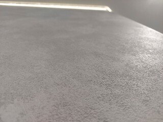 Close-up view of a textured surface showing subtle patterns and colors in a bright, indoor setting during midday