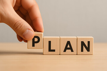 Naklejka premium hand placing wooden block with letter p to complete the word plan representing business planning development strategy goals and objective setting