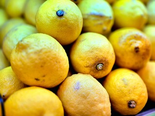 Bright Yellow Lemons Stacked on Market Display