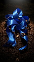 A vibrant blue ribbon with a shiny satin finish is elegantly curled and placed on a dark textured surface, creating a striking contrast and a sense of celebration or gift wrapping
