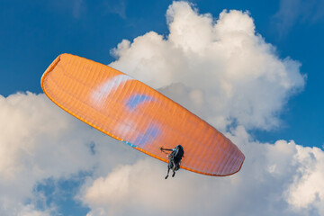 People paragliding in the sky against a backdrop of clouds