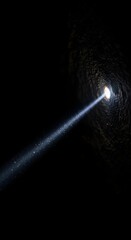 Fototapeta premium A bright beam of light shines into a dark tunnel, creating a striking contrast between darkness and illumination, with a sense of mystery and exploration