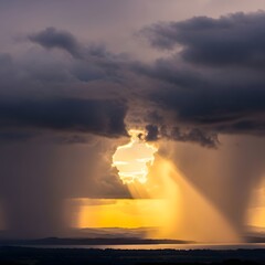 A dramatic sky with dark clouds and bright sunlight breaking through, creating a striking contrast and illuminating the landscape below during a stormy weather scene