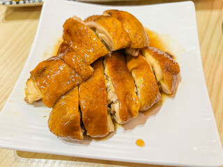A selection of classic Cantonese dim sum including char siu barbecue pork, shrimp dumplings, rose soy chicken, and molten custard buns. The dishes showcase traditional Hong Kong flavors with vibrant