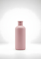 Minimalist studio shot of a single matte pink bottle on a clean white background.