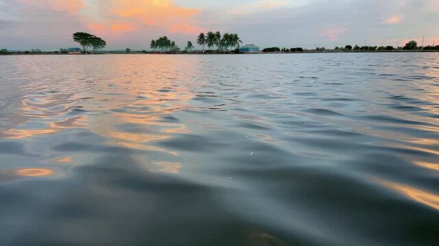 Serene Tropical Sunset Over Calm Waters, Palm Trees Silhouetted, Golden Skies Reflecting on Water