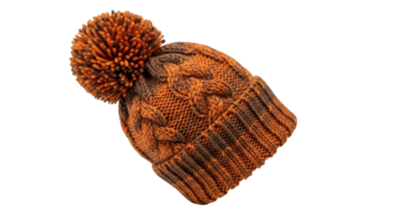 Cozy knitted orange and brown beanie with pom-pom on black background