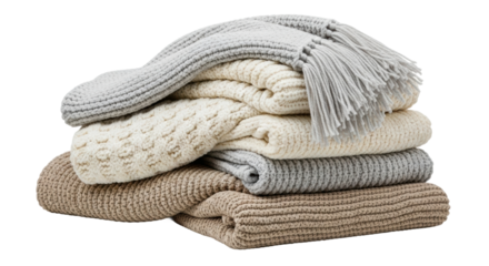 Stack of cozy folded knitted blankets in neutral tones