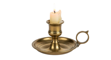 Vintage brass candle holder with lit wax candle on handle