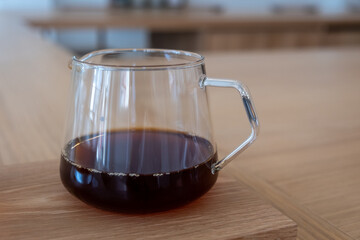 Coffee in a clear kettle, on the wooden table
