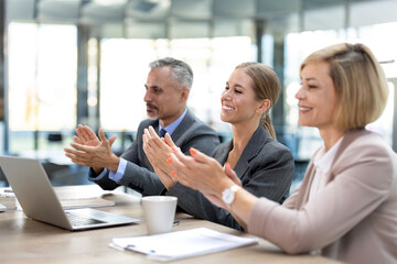 group of diverse business people applauding together.