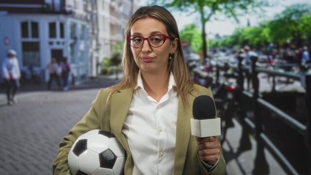 Woman reporter holding microphone and soccer ball on a city street, raised eyebrow gesture; media skepticism.