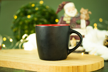 Black cup with space for text in the background New Year or Christmas winter holiday decor