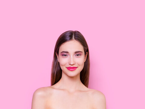 Beautiful brunette young woman with glowing make-up on pink background Fashion model close-up beauty shot stock photo