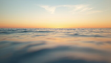 Obraz premium Serene Seascape at Sunset with Soft Waves and Colorful Sky