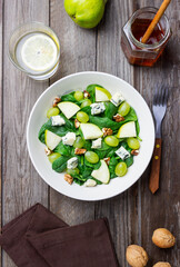 Salad with spinach, blue cheese, pear, grapes, and nuts. Healthy eating. Vegetarian.