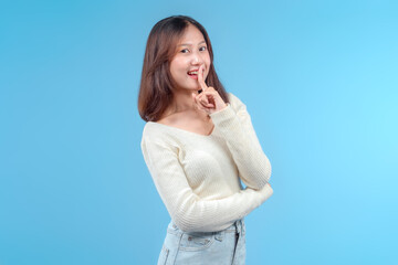 Fototapeta premium Indonesian Woman Making a Playful Shh Gesture