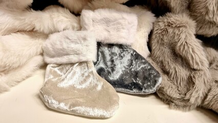 Winter socks for gifts for children in gray and gold colors on a background of winter decorations. Concept of gifts and surprises for children, card