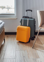 Suitcases standing in modern hotel room ready for travel