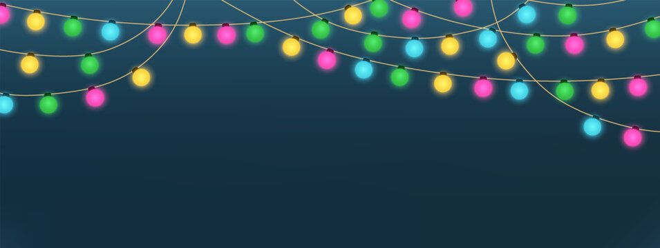 Decorative garland with glowing colorful lights on dark background. Festive composition for celebration, holiday, and party themes