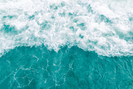 Turquoise olive green ocean wave during summer tide, abstract sea nature background
