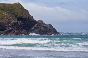 Coastal rocks meet the turbulent sea under a cloudy sky. in Polly Joke - Cornwall - UK