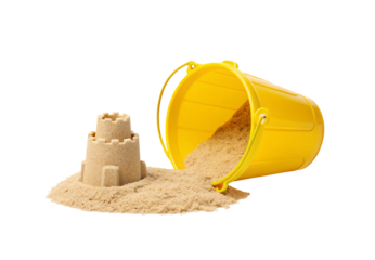 Yellow beach bucket tipped over spilling sand with small castle, isolated on a transparent background