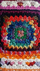 Obraz premium Close-up of a colorful, square, textured crochet piece