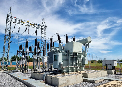 115kV Take-off tower and Transformer feeder in a switchyard of substation on clouds and blue sky background.