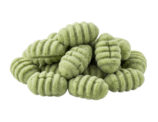 Close-up shot of a pile of green gnocchi pasta, ready to be cooked.