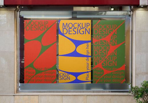 Three vertical AD posters in store window
