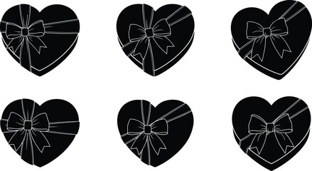 Six black heart shaped gift boxes with white ribbon bows present