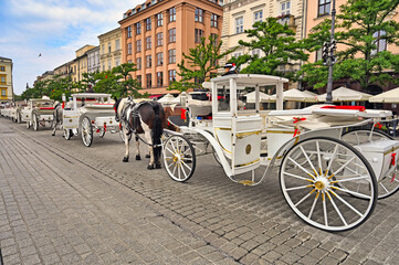 Horse carriages at Main Market Square, in the Old Town of Krakow, Poland