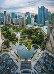 Naklejka premium Aerial view of KLCC Park, Kuala Lumpur, Malaysia, with dramatic sky at