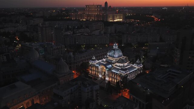 Landmarks of Bucharest. Aerial drone 4K video with CEC Palace and Palace of the Parliament historical buildings in Romania during a summer evening sunset. Travel to Romania.