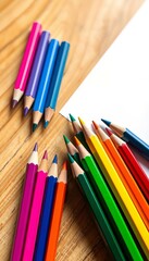 Obraz premium Vibrant colored pencils fanned out on a wooden desk, ready for creative projects, design, art supplies