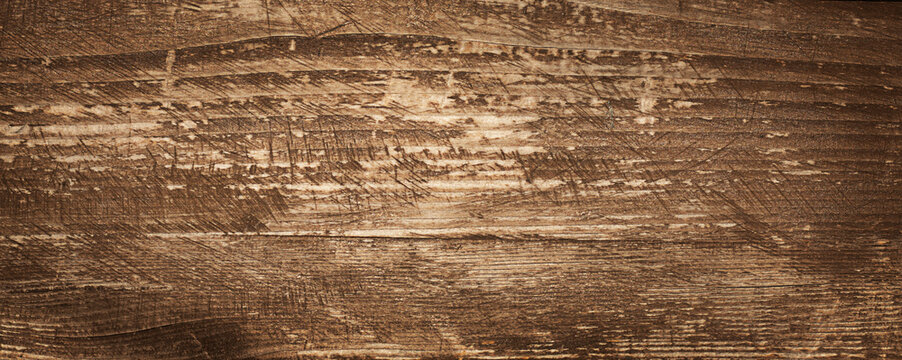 Rustic wood texture background with aged planks and warm brown tones for design projects