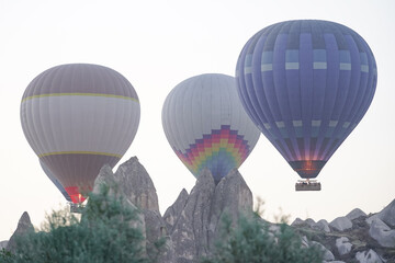 Obraz premium Hot Air Balloons over Cappadocia Valleys in Nevsehir, Turkiye