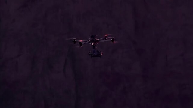 Night Air Patrol. Quadrocopter powerful moves in the night canyon walls in the moonlight. Slow Motion
