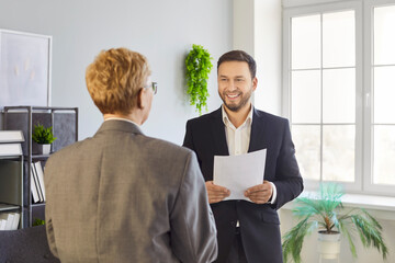Recruiter and job candidate at interview in office. Manager reviews resume, steering a hiring...