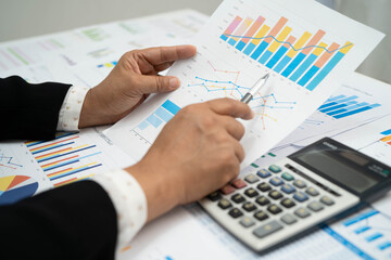 Asian business woman working with financial graph.