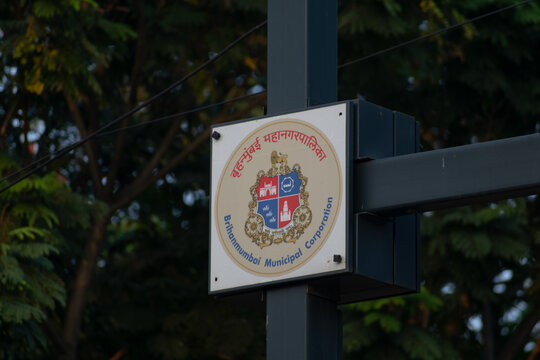 A Brihanmumbai Municipal Corporation MCGM, BMC sign displayed outdoors, representing governance, civic administration, law, order, public services, elections, authority and urban municipal management.