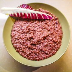 Background with a plate of risotto with red radicchio