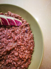 Background with a plate of risotto with red radicchio