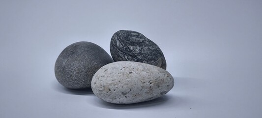 Separated sea pebbles on white background
