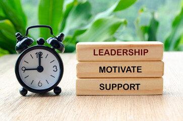 Leadership, motivate and support text on wooden blocks. Leadership concept.