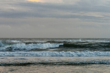 Rolling ocean under cloudy twilight sky